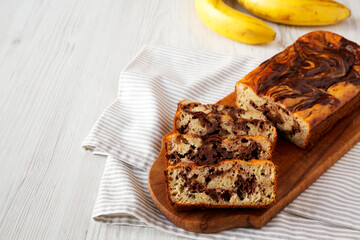 Homemade Chocolate Banana Bread on a rustic wooden board, low angle view. Copy space.