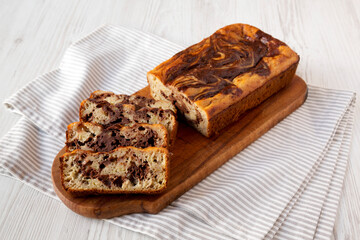 Homemade Chocolate Banana Bread on a rustic wooden board, low angle view.