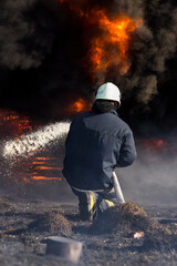 Firefighters extinguish a fire. Lifeguards with fire hoses in smoke and fire