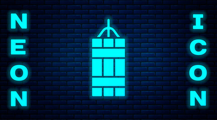 Glowing neon Detonate dynamite bomb stick icon isolated on brick wall background. Time bomb - explosion danger concept. Vector.