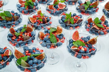 Raspberries, blackberries and blueberries. There are wonderful and delicious berries in a glass plate. Healthy and wholesome food