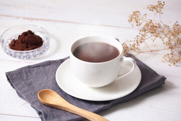 cup of hot chocolate with white wooden background