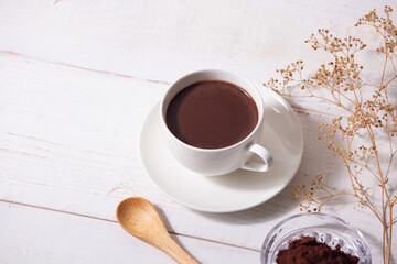 cup of hot chocolate with white wooden background