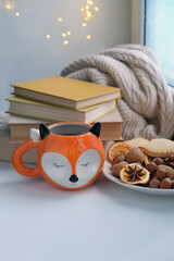 Tea Cup, cookies, nuts, books, sweater. home comfort. relax and reading. autumn or winter season. 