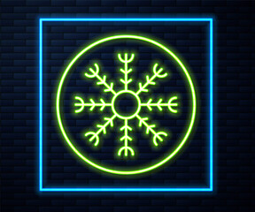 Glowing neon line Snowflake icon isolated on brick wall background. Vector.