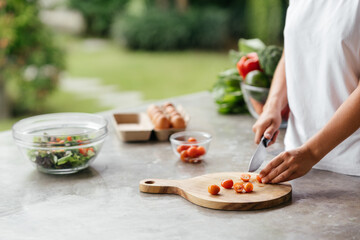 Human hands cooking vegetables salad in open kitchen