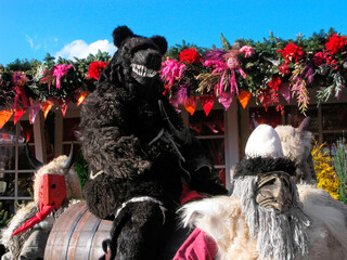 Maslenitsa holiday, street actors in masks, one in bear costume