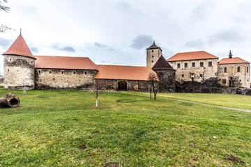 Massive and well fortified medieval Water Castle of Svihov is situated in the Pilsen Region, Czech Republic, Europe. There are water canal around the stone castle. Winter view.