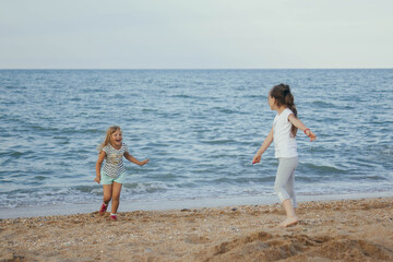 A smiling child plays by the sea