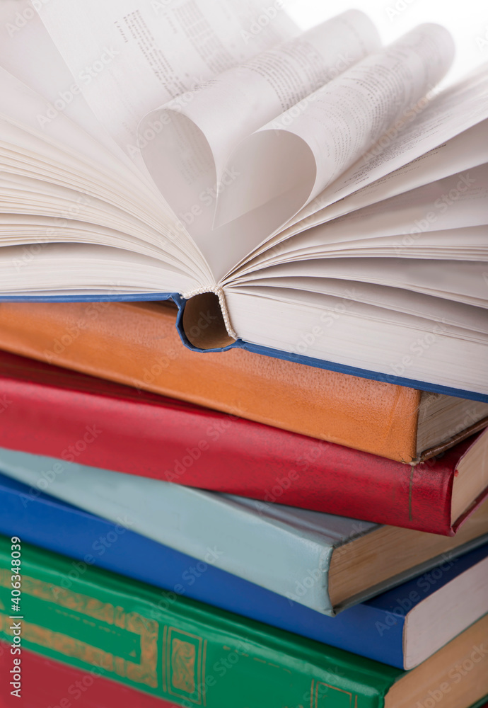 Poster the book opens, and the book page rolls into the heart selective focus and with a very shallow depth