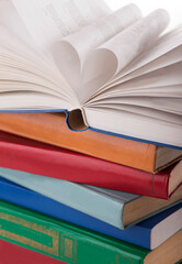 The book opens, and the book page rolls into the heart selective focus and with a very shallow depth of field