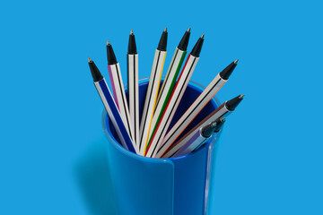 pens lying in a blue penholder