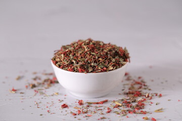 dried strawberries with a stalk and a leaf are on the table