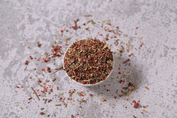 dried strawberries with a stalk and a leaf are on the table