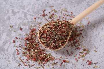 dried strawberries with a stalk and a leaf are on the table