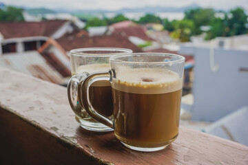 Two cups of coffee on the windowsill