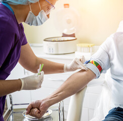 Nurse taking a patient's blood sample at lab