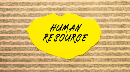 Yellow torn paper with the text HUMAN RESOURCE on a gray-pink background.