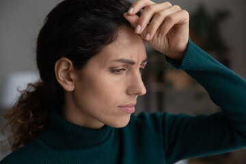 Unhappy young Caucasian woman look in distance upset distressed with bad news or message. Sad...