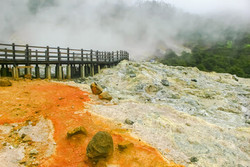 bridge and mist in Sikidang Crater. Dieng, Indonesia