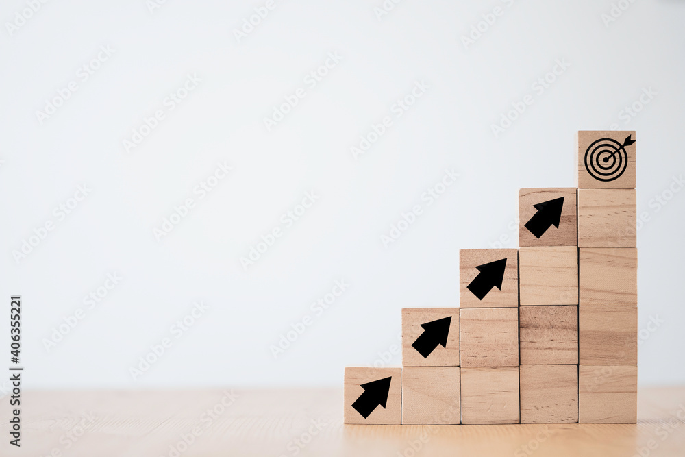 Poster virtual target board and increasing arrow which print screen on wooden cube. business achievement go