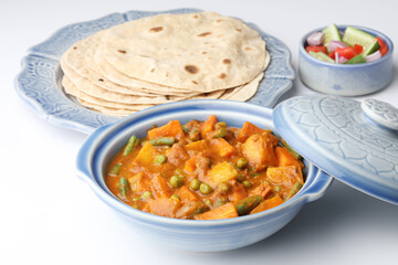 Mix vegetables curry of beans, carrot potato and green peas with Roti and salad. Indian food