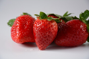 Strawberry fresh organic fruit. Strawberries with leaves. Isolated on a white background.