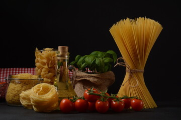 Various types of Italian pasta. Uncooked spaghetti , tagliatelle. Italian food ingredients for  pasta