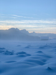 Bizarre, otherworldly winter landscape around frozen covered in ground fog