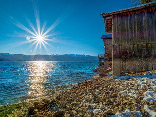 Walchensee as one of beautiest Bavarian lakes during sunrise phase with warm blue sky scenery with...