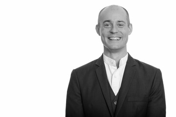 Portrait of happy handsome bald businessman in suit smiling