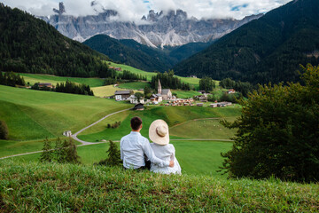 Fototapeta na wymiar Happy couple spending vacation at italian dolomites mountains
