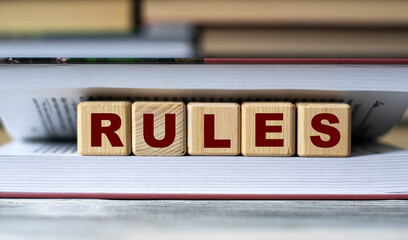 RULES - word on wooden cubes against the background of the open book