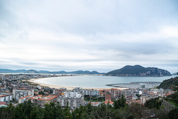 Aerial view of Laredo beach with the island of Santoña in the background in a sunset