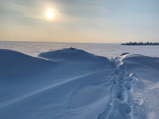 Winter Trail on a frozen river consecrated by the sun
