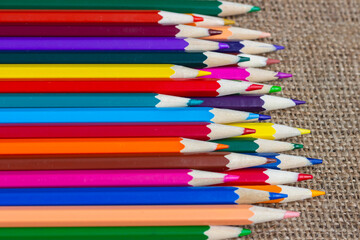 Set of colorful pencils on burlap.