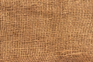 The texture of an uneven crumpled, roughly woven burlap.