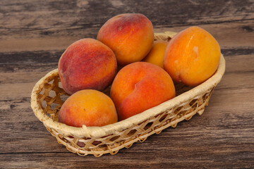 Peach heap in the wooden basket