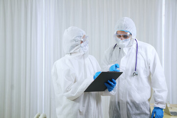 Fototapeta premium Medical team in Personal Protective Equipment or PPE clothing Researching and Discussing for patients infected with the Covid 19 virus and treatment in emergency and lab at hospital in Thailand