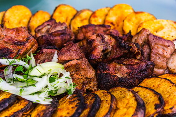 pork and potatoes in pieces grilled selective focus