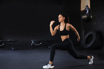 Fototapeta na wymiar Beautiful muscular fit woman exercising building muscles.