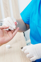 Taking blood from a finger for analysis. Fingerstick sampling for complete blood count