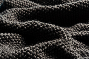 soft knitted plaid of woolen yarn closeup. texture. background