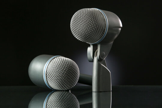 Microphone on a black background with gradient.