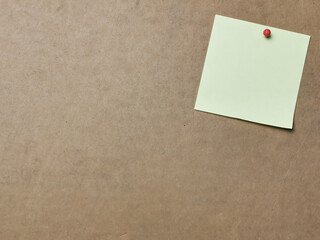 Fototapeta premium Yellow paper note with pin board over brown background.Copy space.