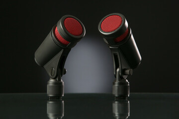 Microphone on a black background with gradient.