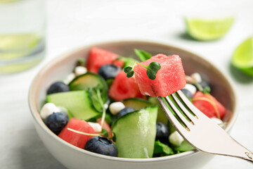 Delicious salad with watermelon served in bowl, closeup