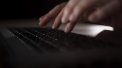 Hands typing on laptop keyboard. Close-up of hands typing on laptop keyboard while working at home. Concept of e-learning.