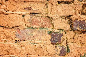 A fragment of a worn brick wall close-up