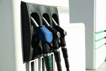 Petrol pump filling nozzles at gas station